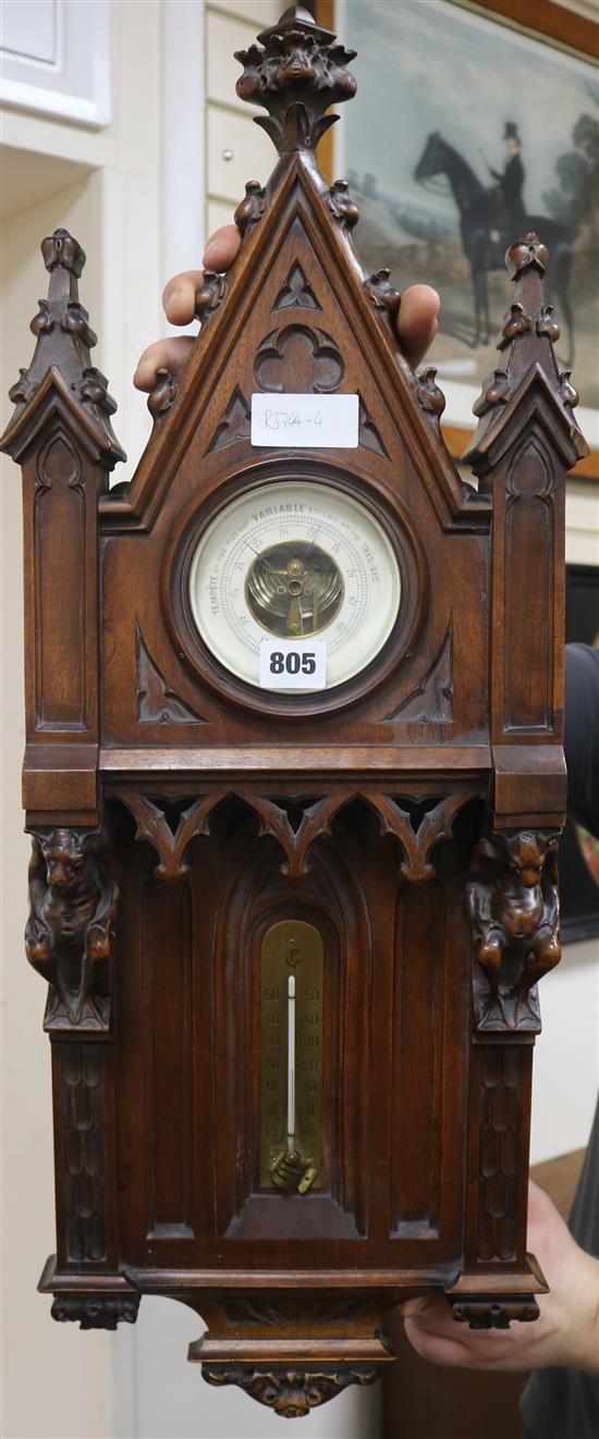 A late 18th century French gothic design carved walnut aneroid barometer and thermometer H.76cm